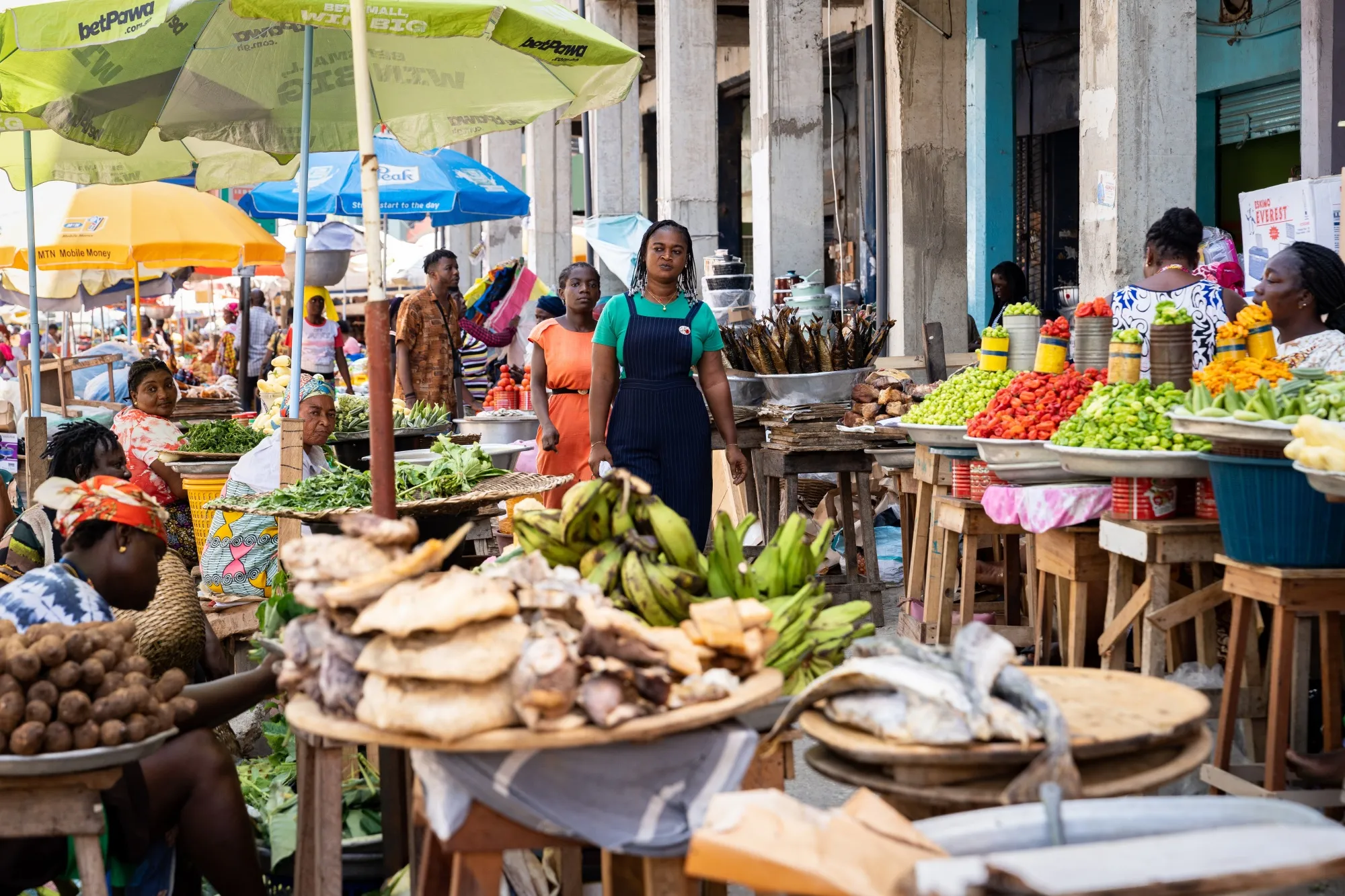 Shoppers walk through a food market in Accra, Ghana.