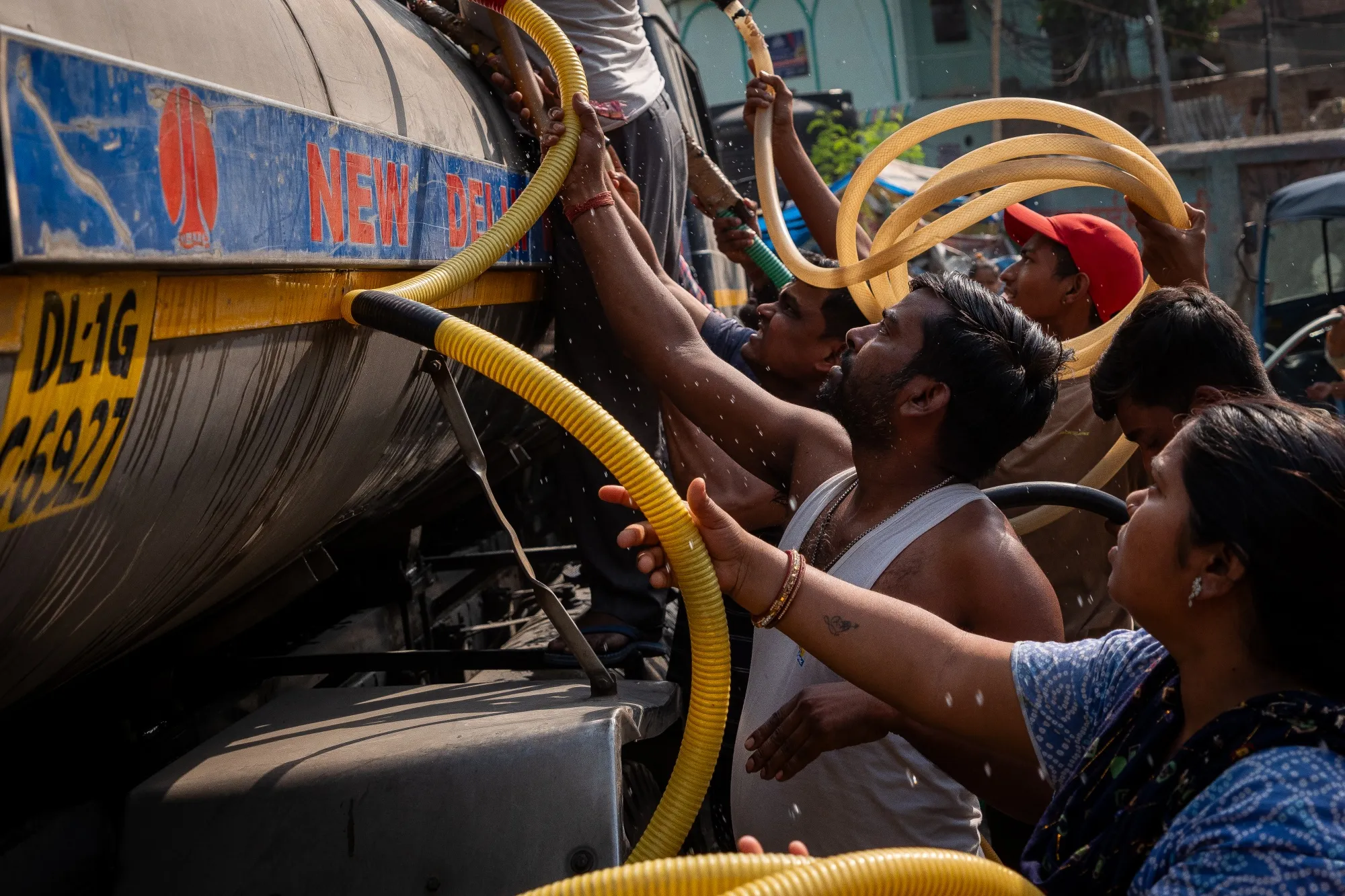 People gather around a municipal tanker to collect water during high temperatures in New Delhi, India&nbsp;on May 18.