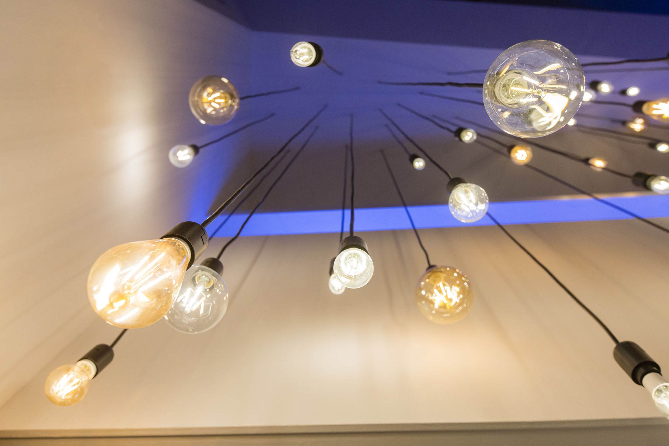 LED bulbs hang at the Royal Philips NV exhibition stand during the Building + Light trade fair in Frankfurt, Germany, on March 15, 2016.
