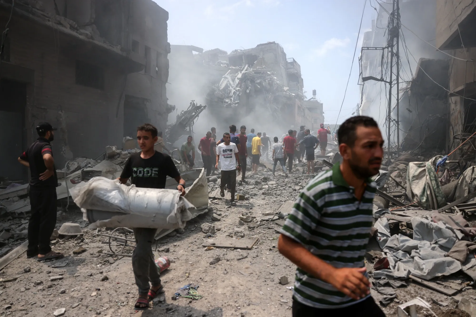 Palestinians check the devastation following an Israeli strike that hit Gaza on Aug. 8.