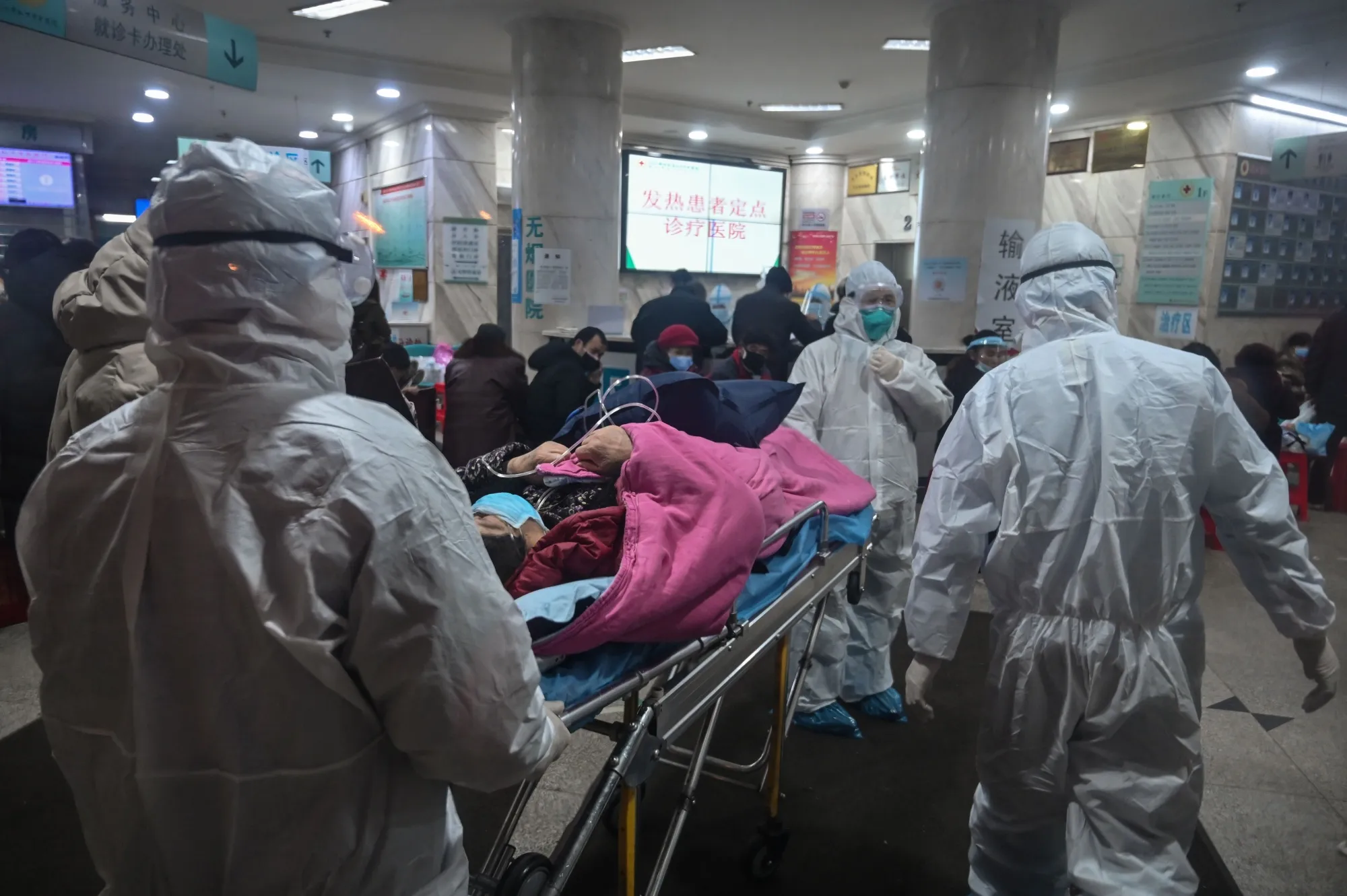 Medical staff arrive with a suspected Covid-19 patient at Wuhan’s Red Cross Hospital in Jan.