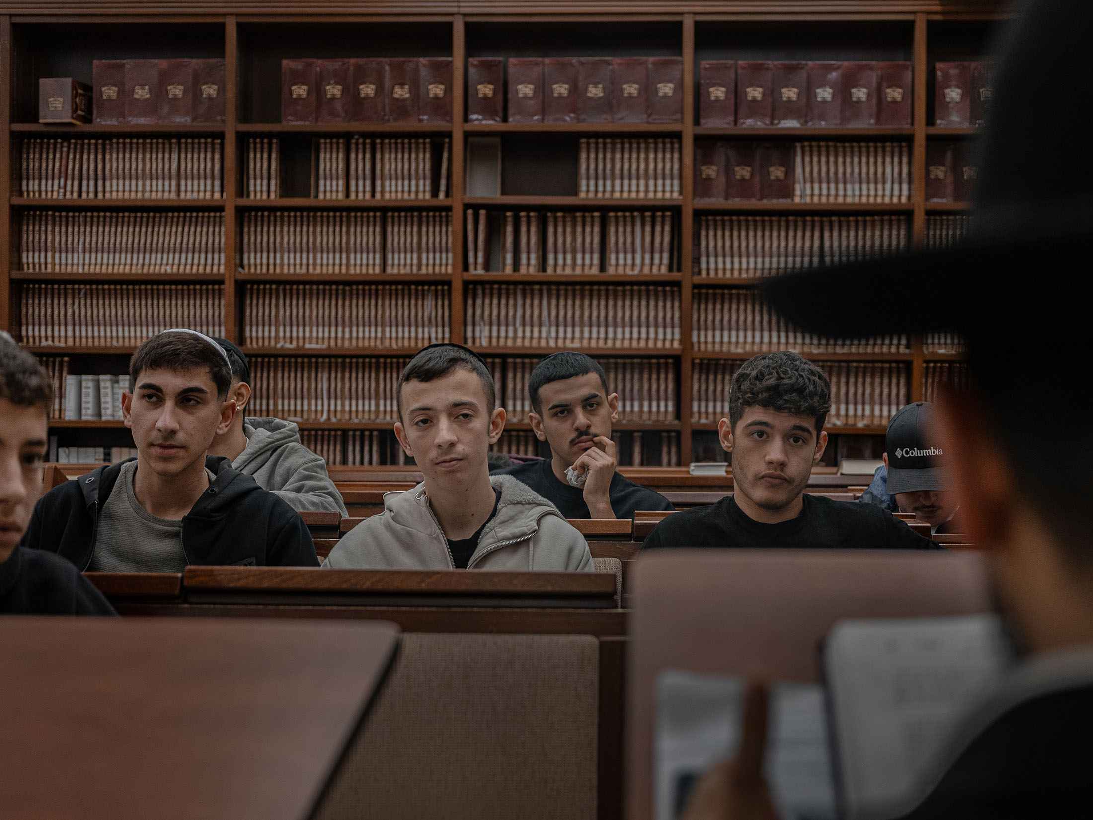 Malik (middle) at a Torah class in his synagogue.