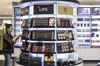 A customer browses a display of cosmetics.