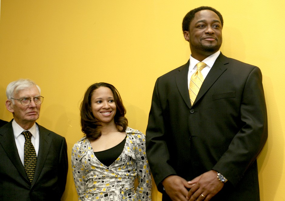 Team owner Dan Rooney (left) announced the hiring of Mike Tomlin (with his wife, Kiya) as the Pittsburgh Steelers' first African-American head coach in 2007.