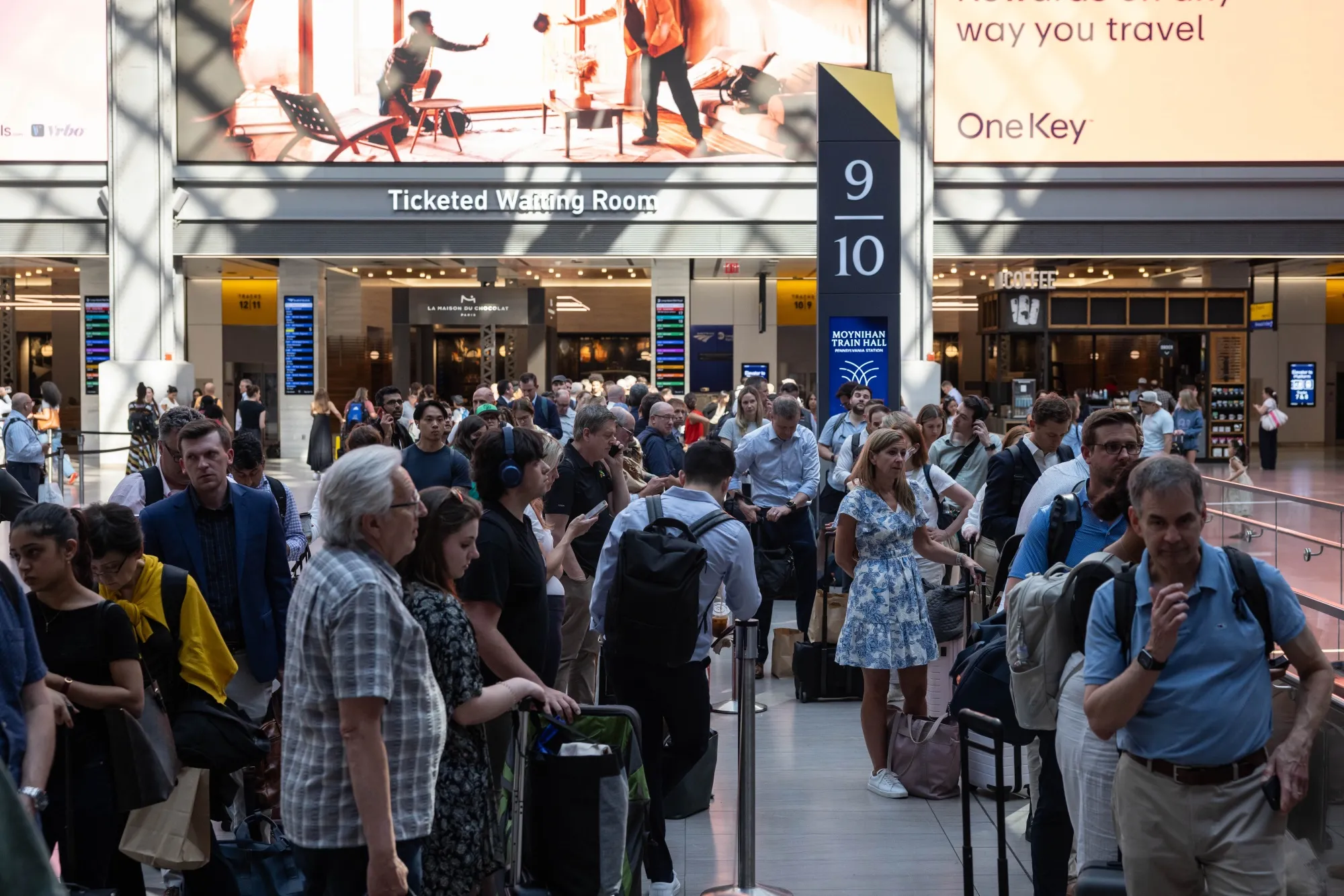 Commuters wait for an Amtrak train in Moynihan Train Hall at Penn Station in New York on June 18, 2024. 