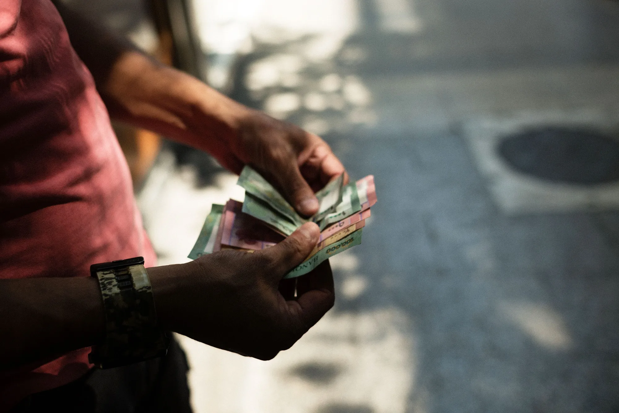 A man counts out Lebanese pound banknotes in Beirut.