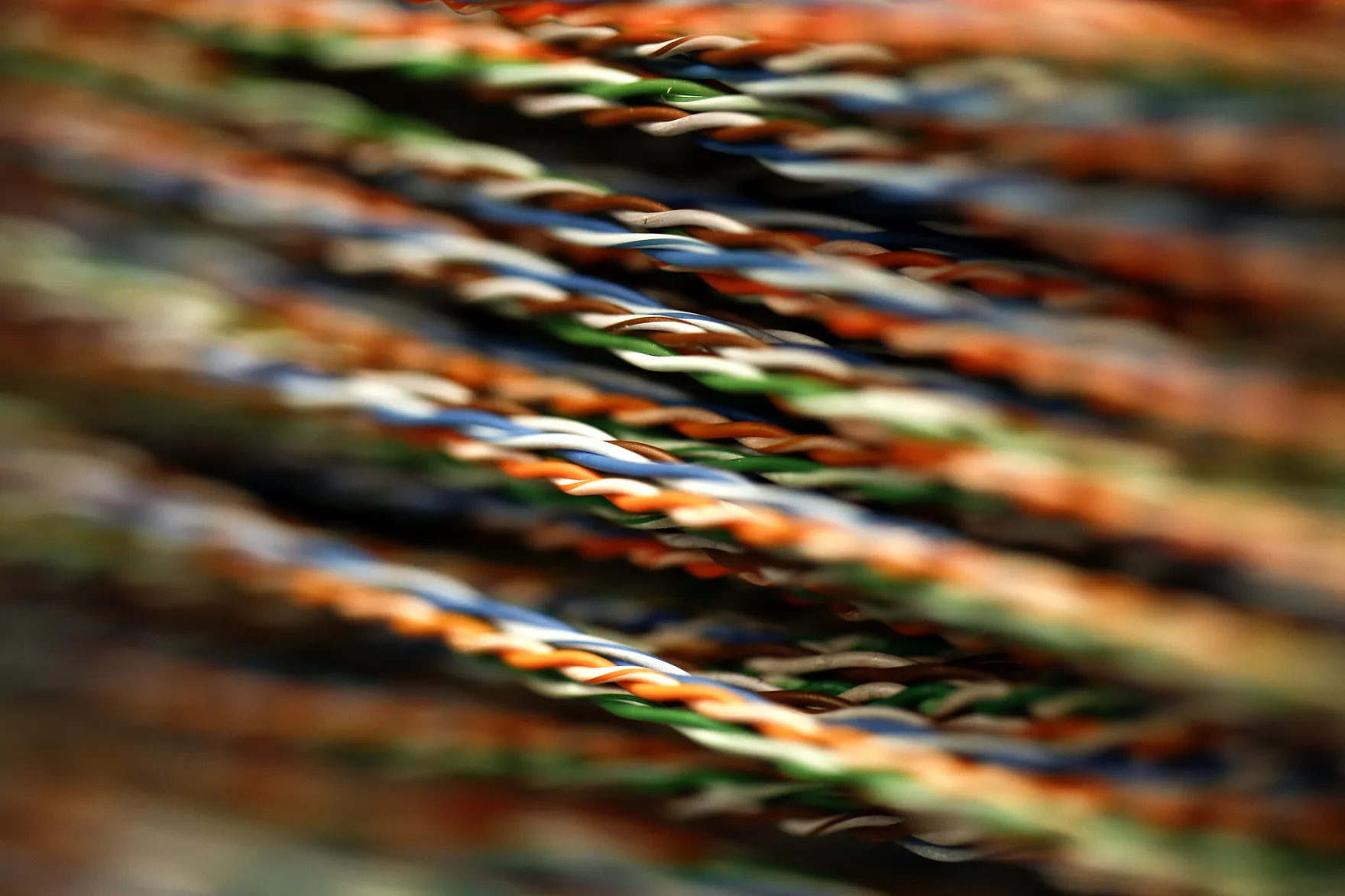 Rows of colored jumper wires are seen inside a comms room at an office in London, U.K., on Tuesday, Dec. 23, 2014. Vodafone Group Plc will ask telecommunications regulator Ofcom to guarantee that U.K. wireless carriers, which rely on BT's fiber network to transmit voice and data traffic across the country, are treated fairly when BT sets prices and connects their broadcasting towers.