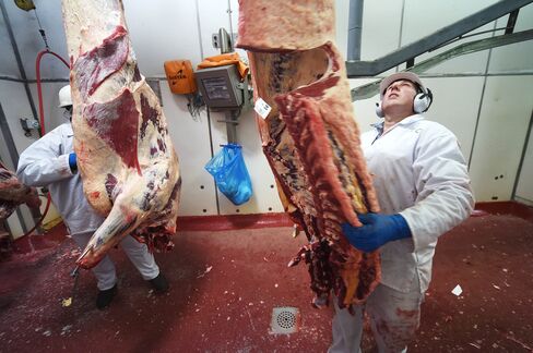 A factory worker moves cattle meat from the chill room to the boning room at a Bindaree Beef facility in Inverell, Australia.