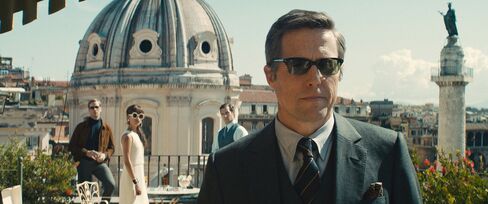 On a rooftop in Rome, Hugh Grant makes a cameo in Oliver Peoples sunglasses.