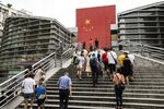 People walk up steps at a border crossing facility in the Sha Tou Jiao Port of Shenzhen, China in 2019.