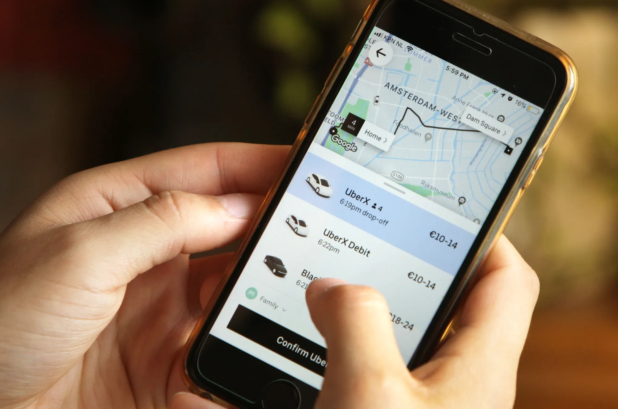 A woman checks the Uber transport application on a smartphone in Amsterdam.