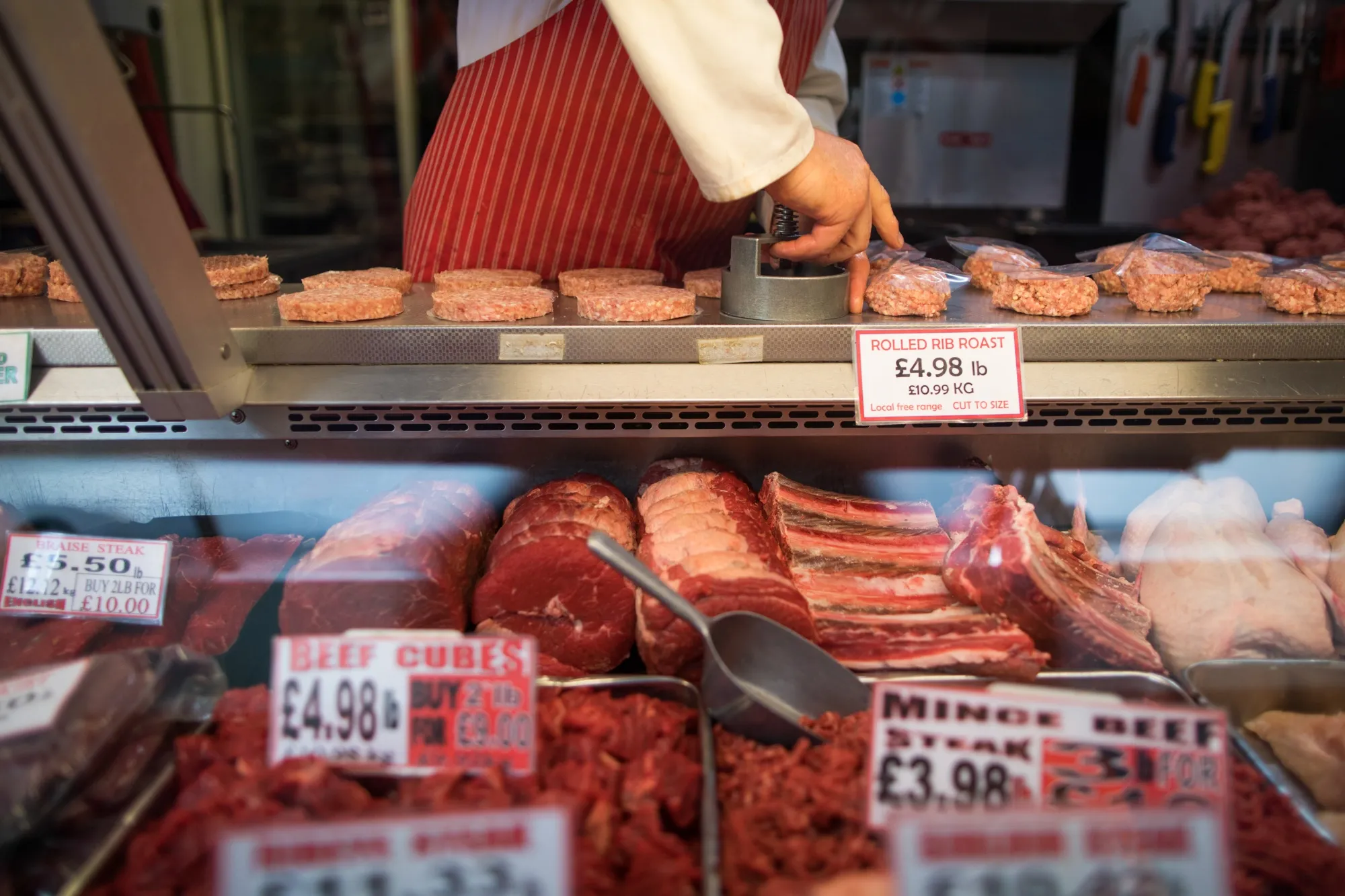 A butcher prepares beef burger patties&nbsp;at a market in Norwich, UK.