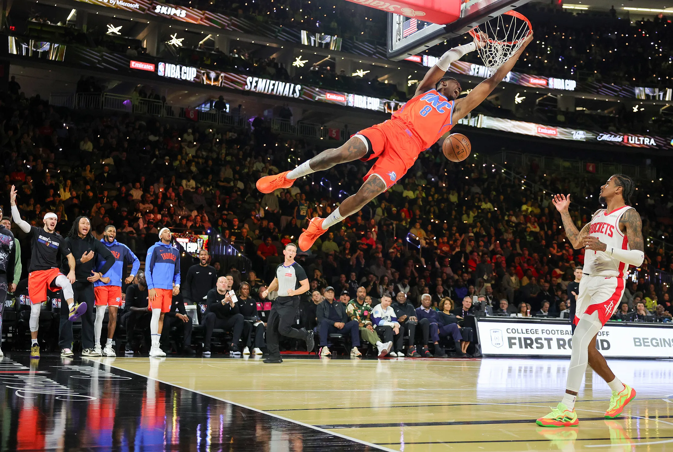 Jalen Williams of the Oklahoma City Thunder dunks ahead of Jalen Green of the Houston Rockets in the second half of a semifinal game of the Emirates NBA Cup at T-Mobile Arena in Las Vegas on Dec.&nbsp;14.