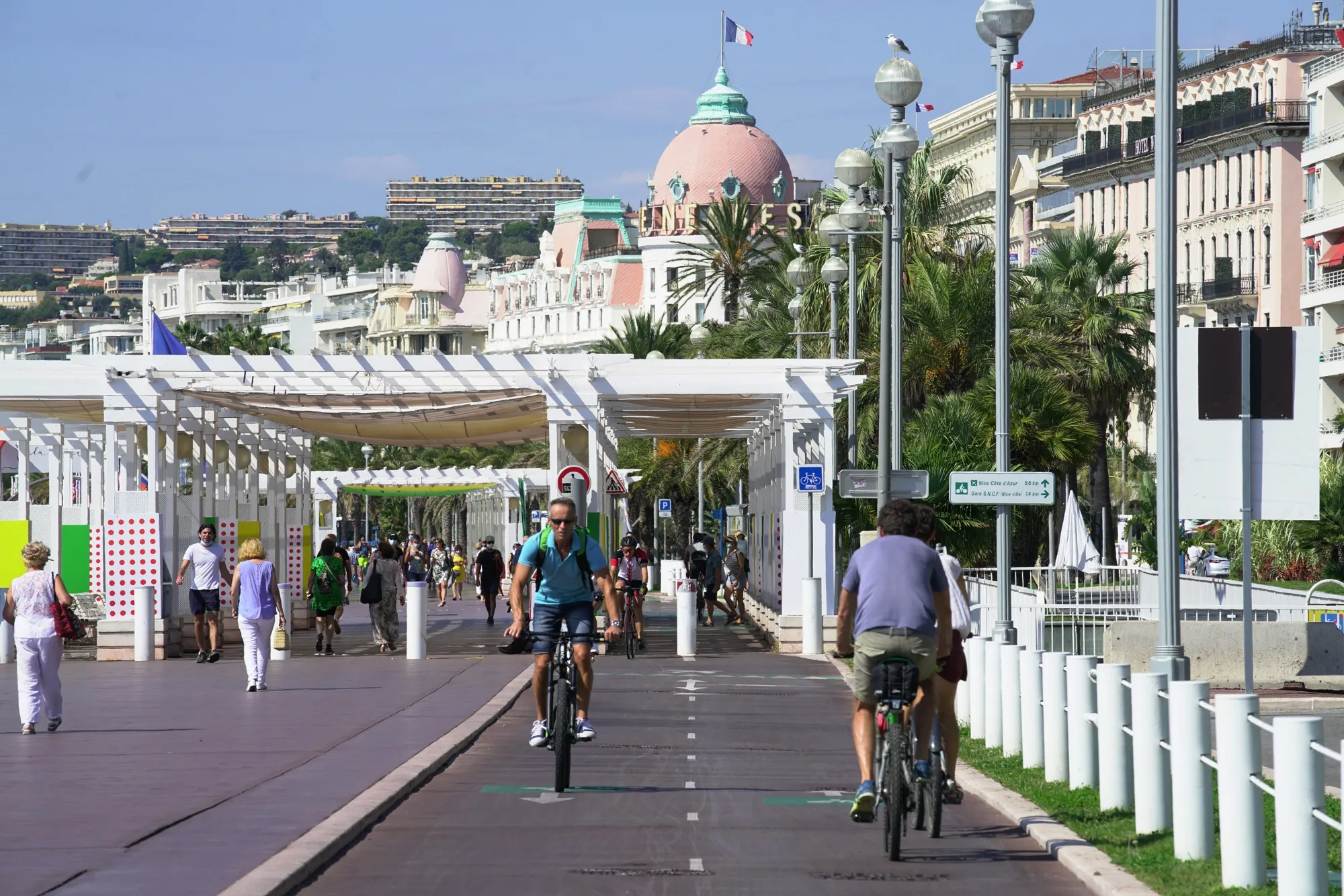 Cyclists use a bike lane beside pedestrians on Promenade des Anglais in Nice, France, in 2020.&nbsp;