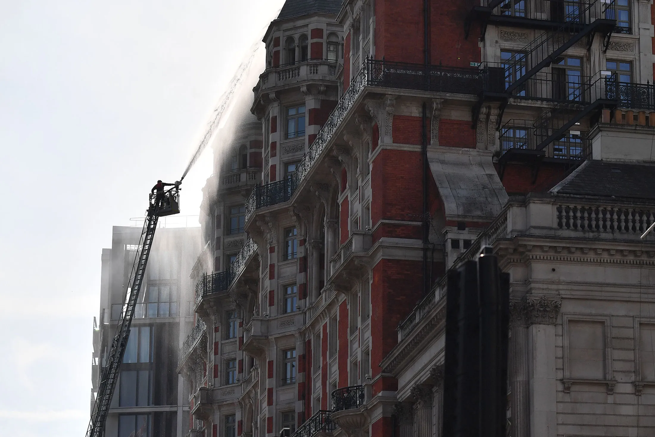 Firefighters tackle a blaze at the Mandarin Oriental hotel in London on June 6.