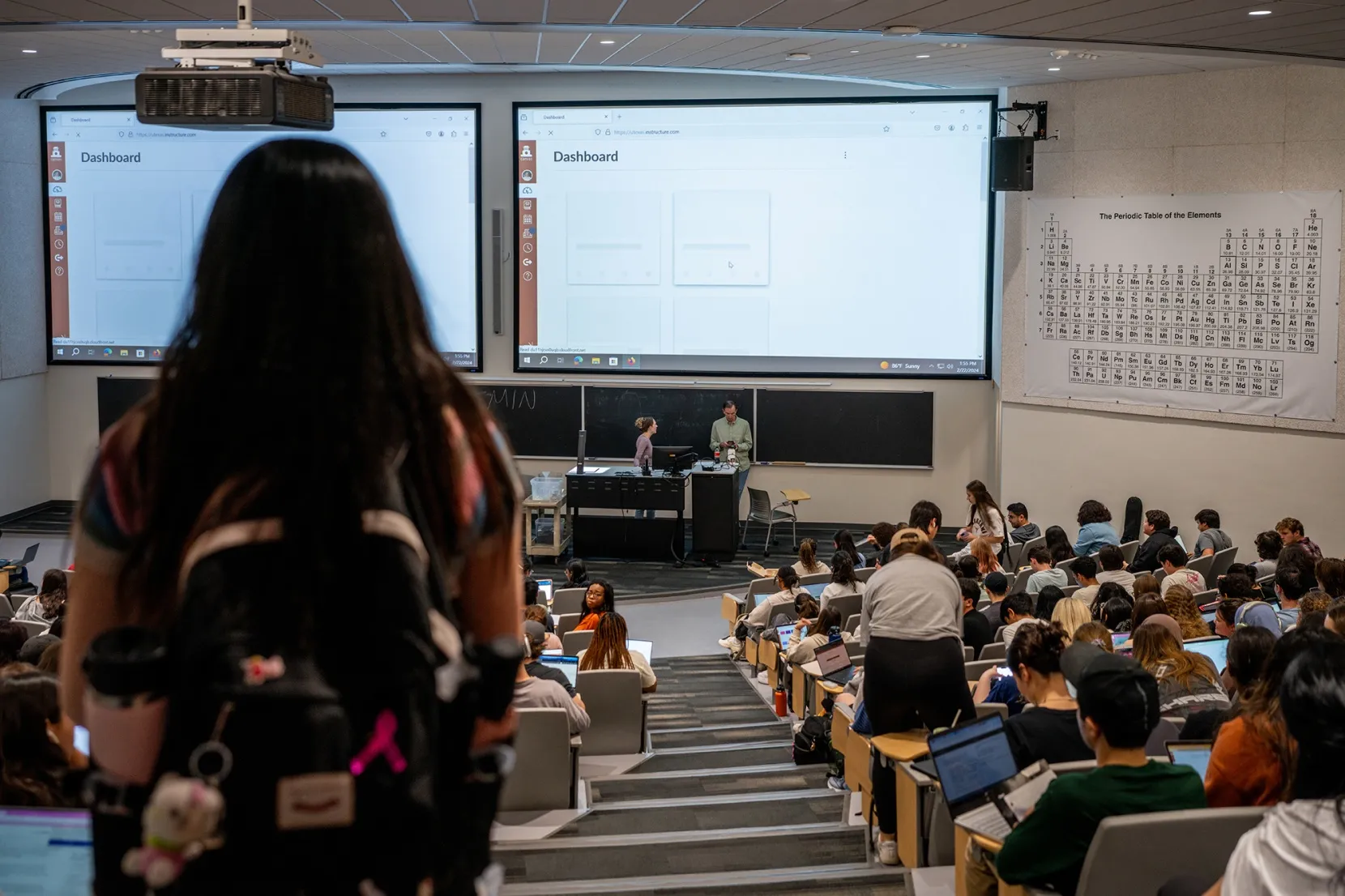 A student looks for a seat ahead of lecture at a university.