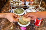 A customer pays with a Kuwaiti dinar banknote&nbsp;in Kuwait City, Kuwait.&nbsp;