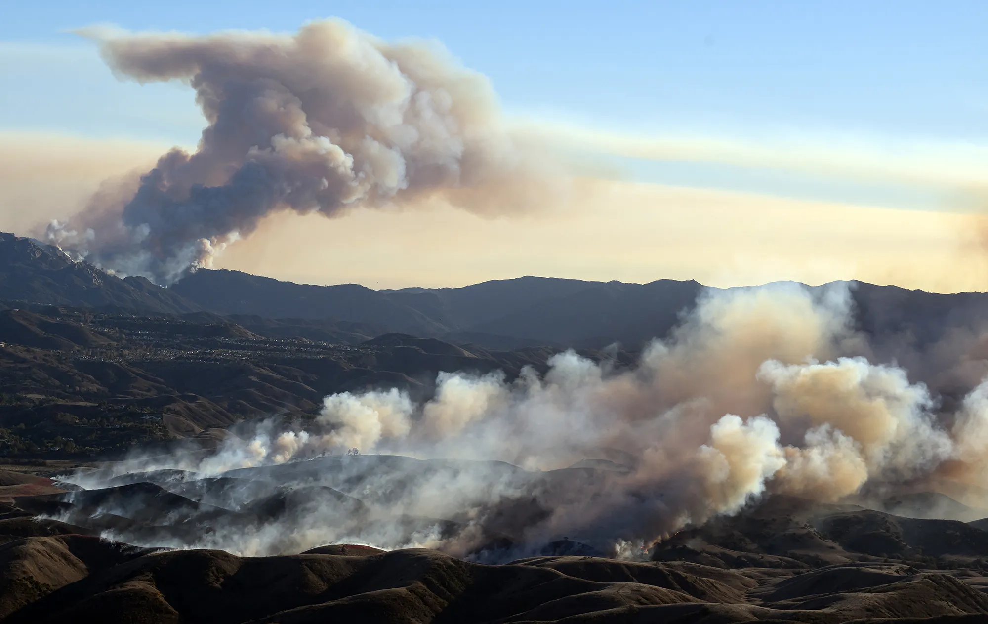 The Kenneth fire, front, approaches homes while the back side of the Palisade fire continues to burn Los Angeles county, California, on Jan. 9.