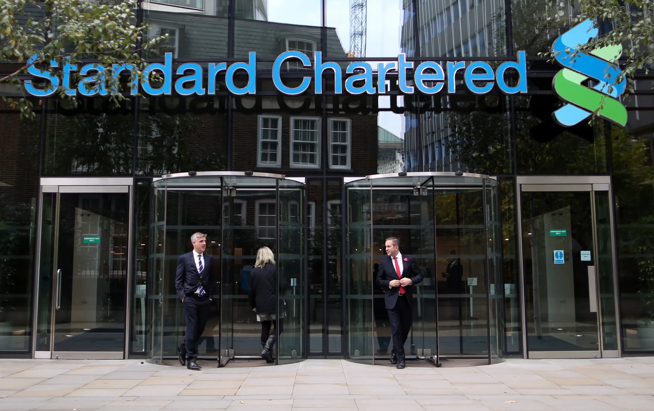 Visitors leave the headquarters of Standard Chartered Plc in London.