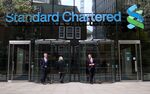 Visitors leave the headquarters of Standard Chartered Plc in London.