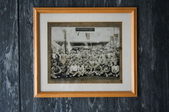 A memorial photograph of miners during a festival at the Harutori Shrine displayed at a coal-mining museum. Photographer: Noriko Hayashi/Bloomberg
