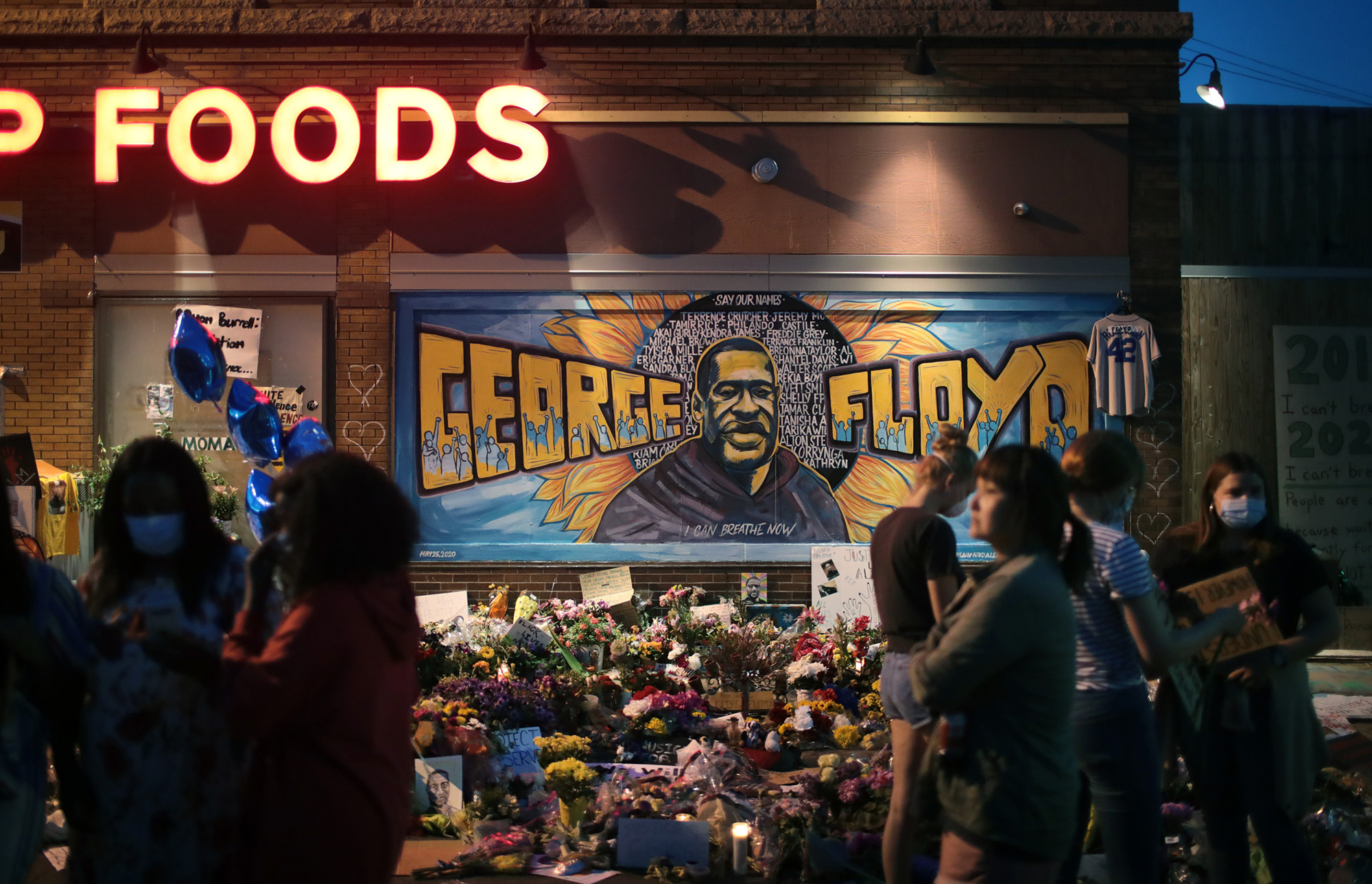 People visit a memorial at the site where George Floyd was killed&nbsp;in Minneapolis on June 3.&nbsp;