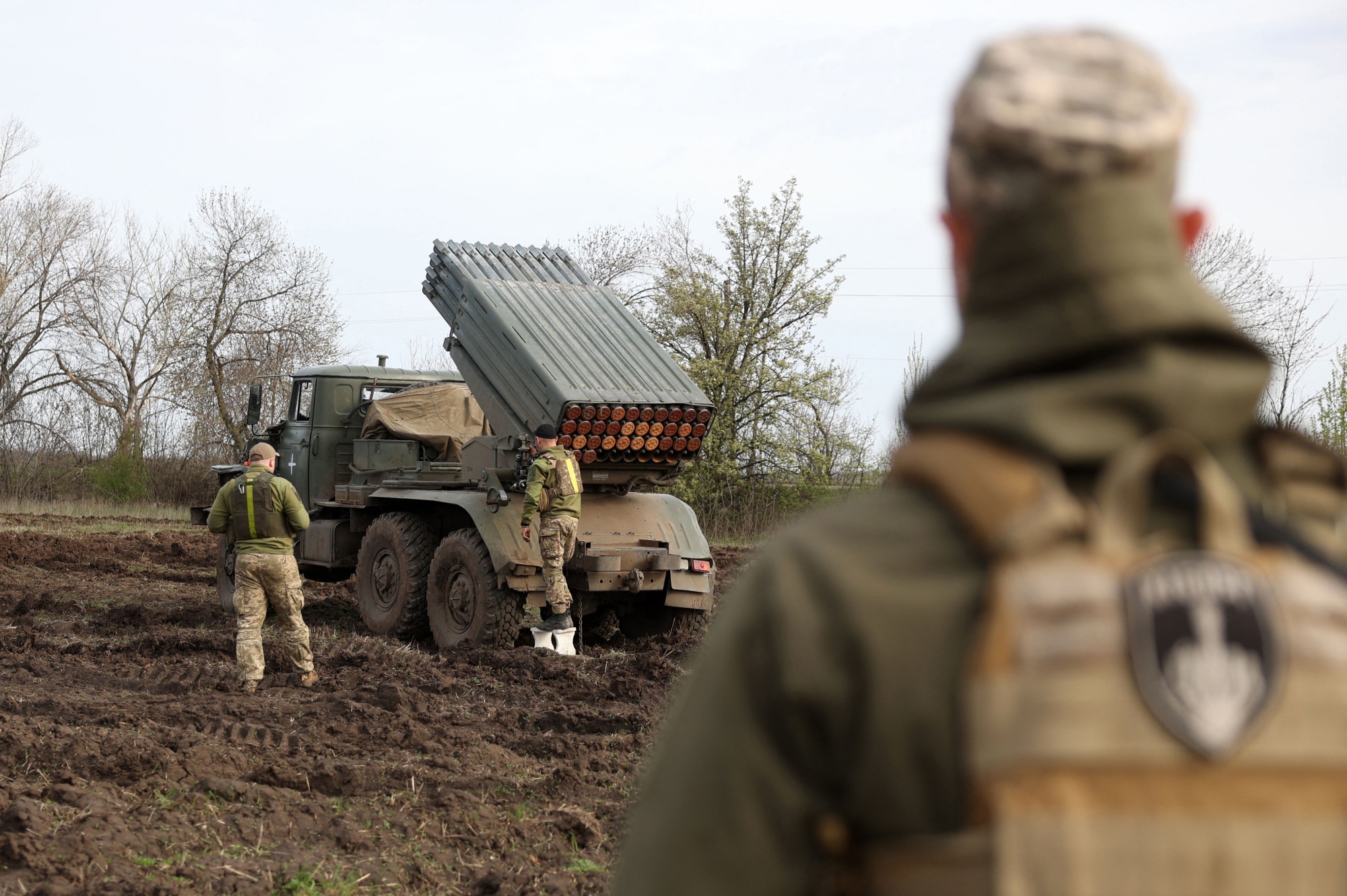 Artillerymen prepare a rocket launcher for fire near Bakhmut.