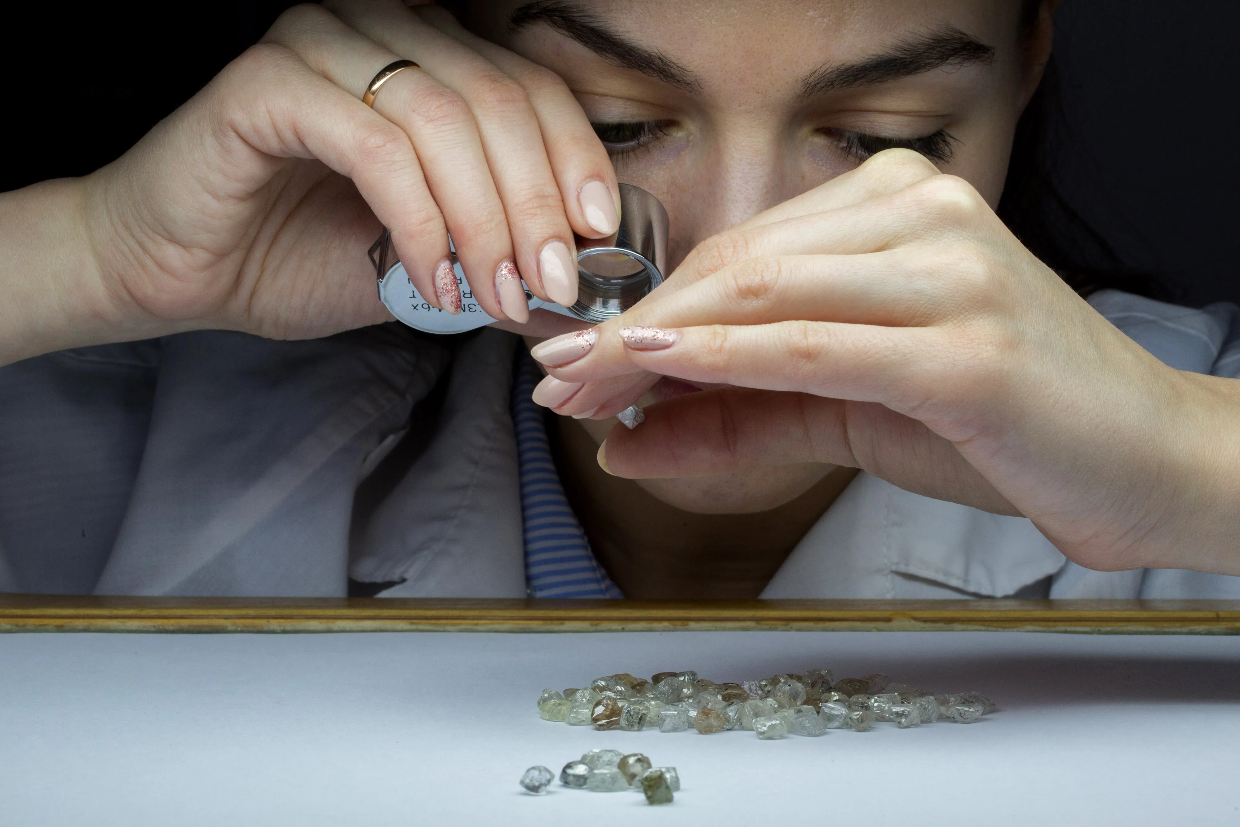 Rough diamonds are inspected at a sorting center in Moscow.