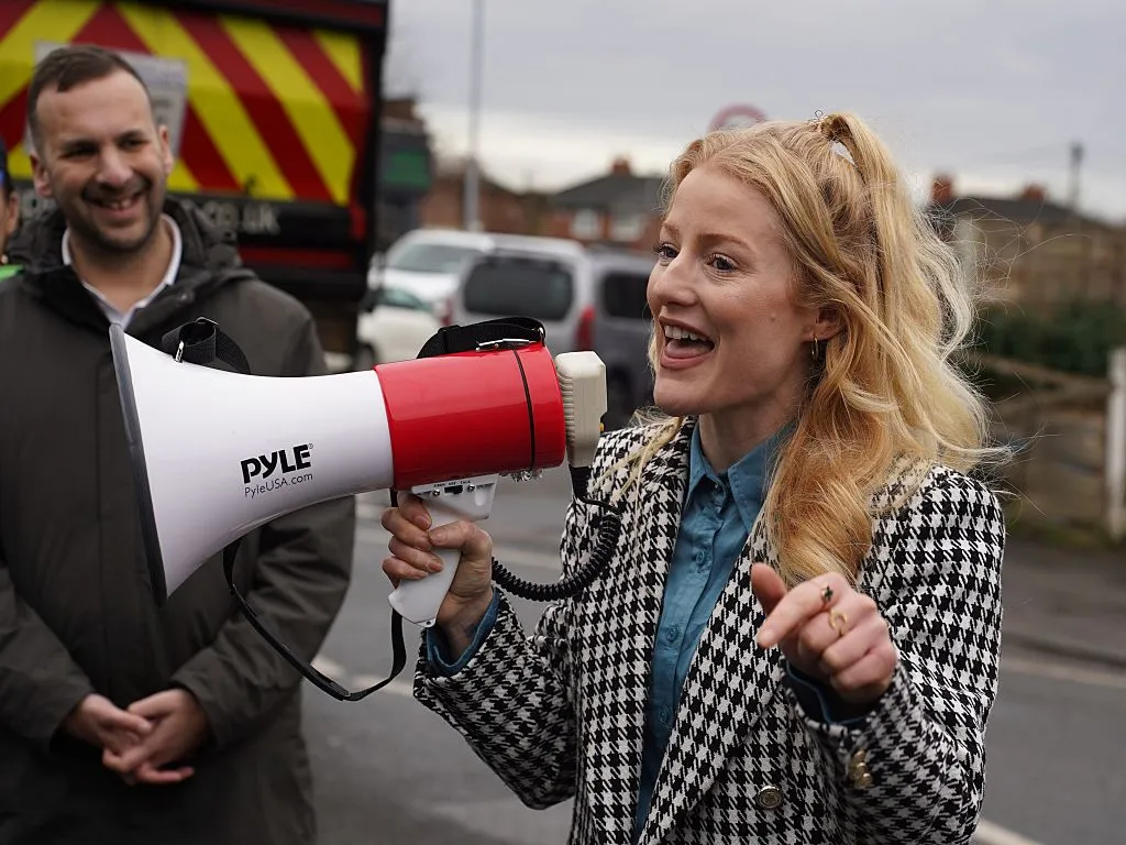 Green Party candidate Hannah Spencer talks with supporters in Manchester.