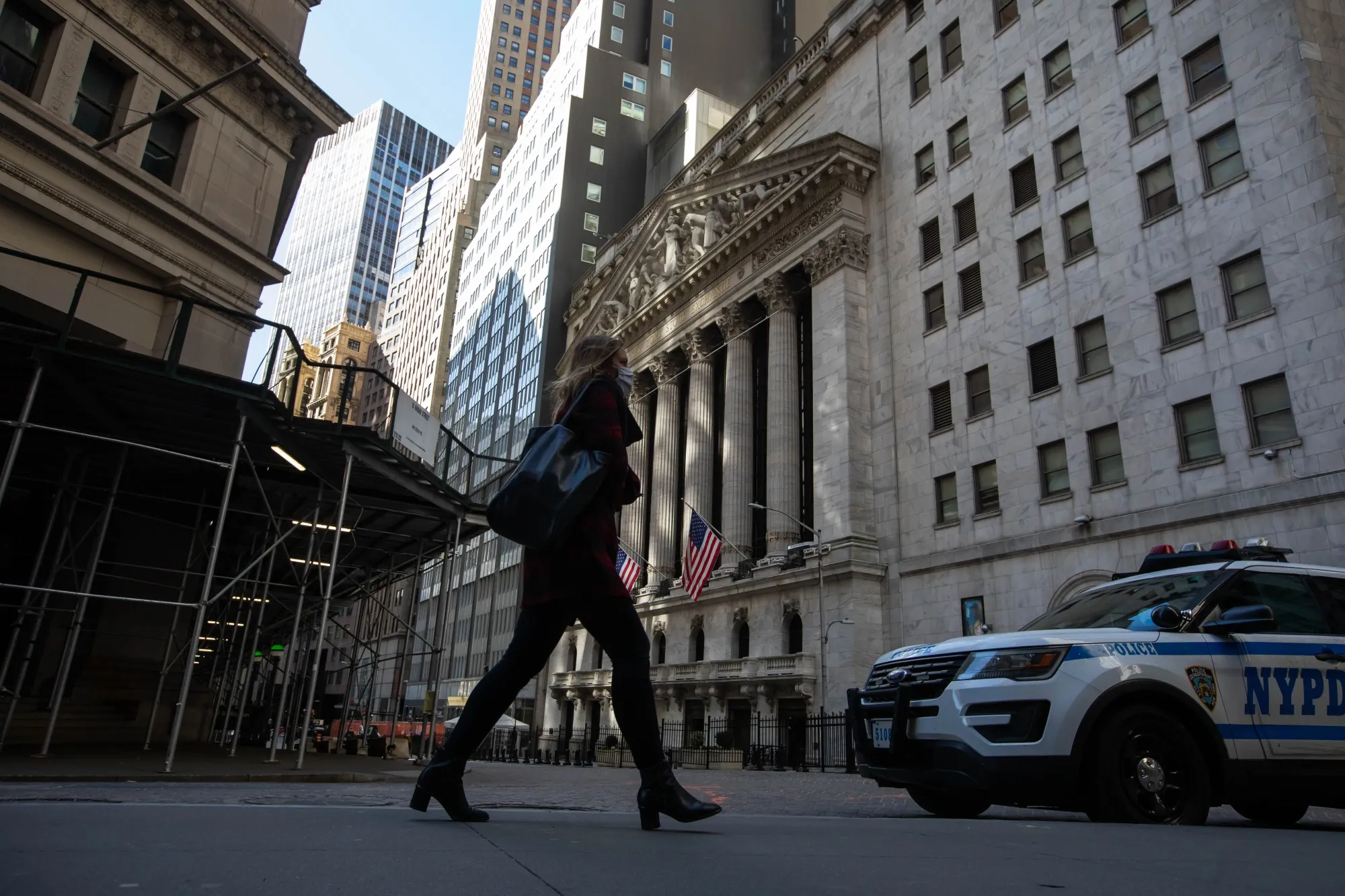 A pedestrian passes in front of the New York Stock Exchange (NYSE) in the Financial District of New York, U.S., on Friday, March 5, 2021. Stocks climbed as technology shares rebounded from an earlier selloff.