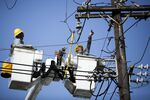 Puerto Rico Electric Power Authority (PREPA) employees fix power lines in Santurce, San Juan, Puerto Rico, on Thursday, Oct. 19, 2017.