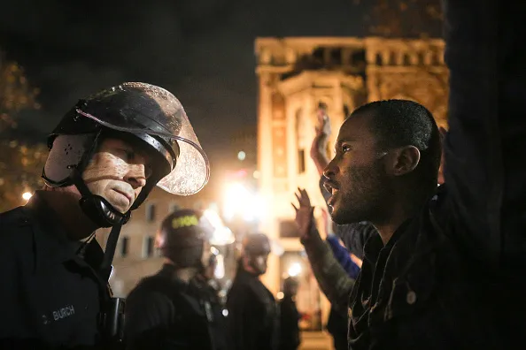 Protesters find themselves face-to-face with armed police.
