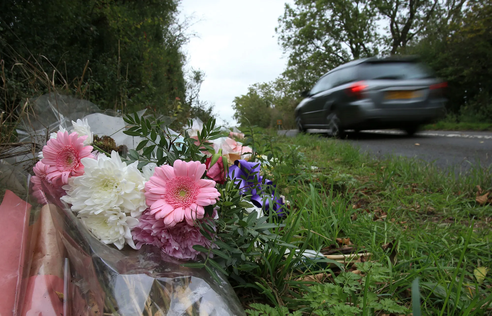 Floral tributes lay on the roadside near RAF Croughton in Northamptonshire.&nbsp;