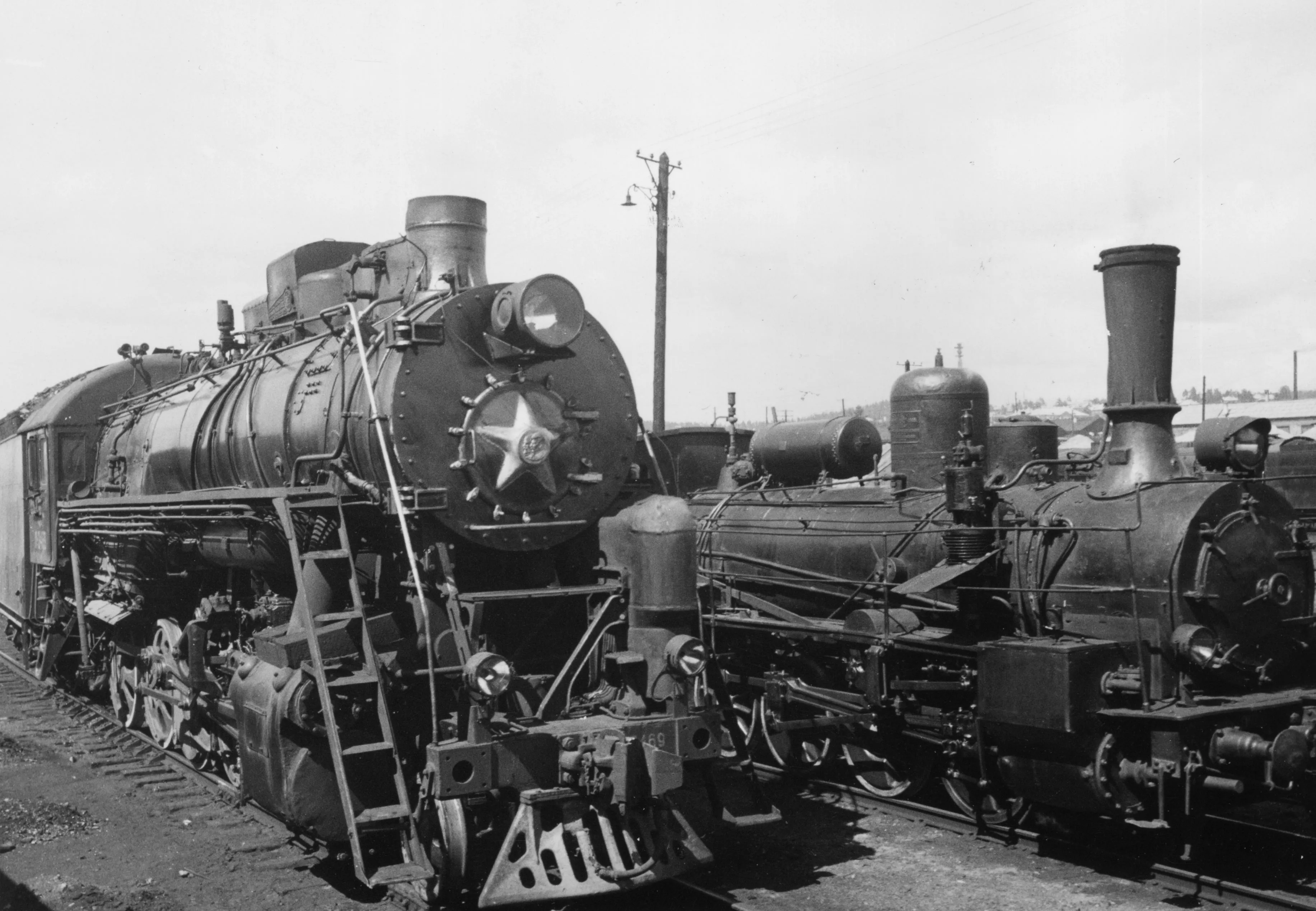 Two steam locomotive trains that traveled from Vladivostok to Sloubliana on the Trans-Siberian railroad line, circa 1955.