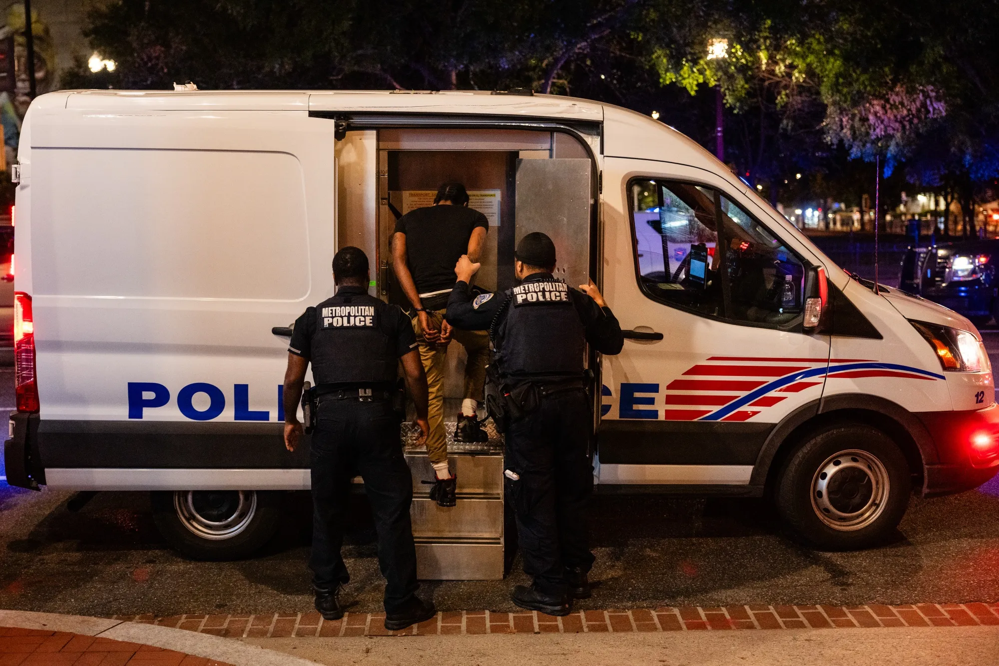 Metropolitan Police Department officers make an arrest during a traffic stop near Chinatown in Washington on Aug. 21.
