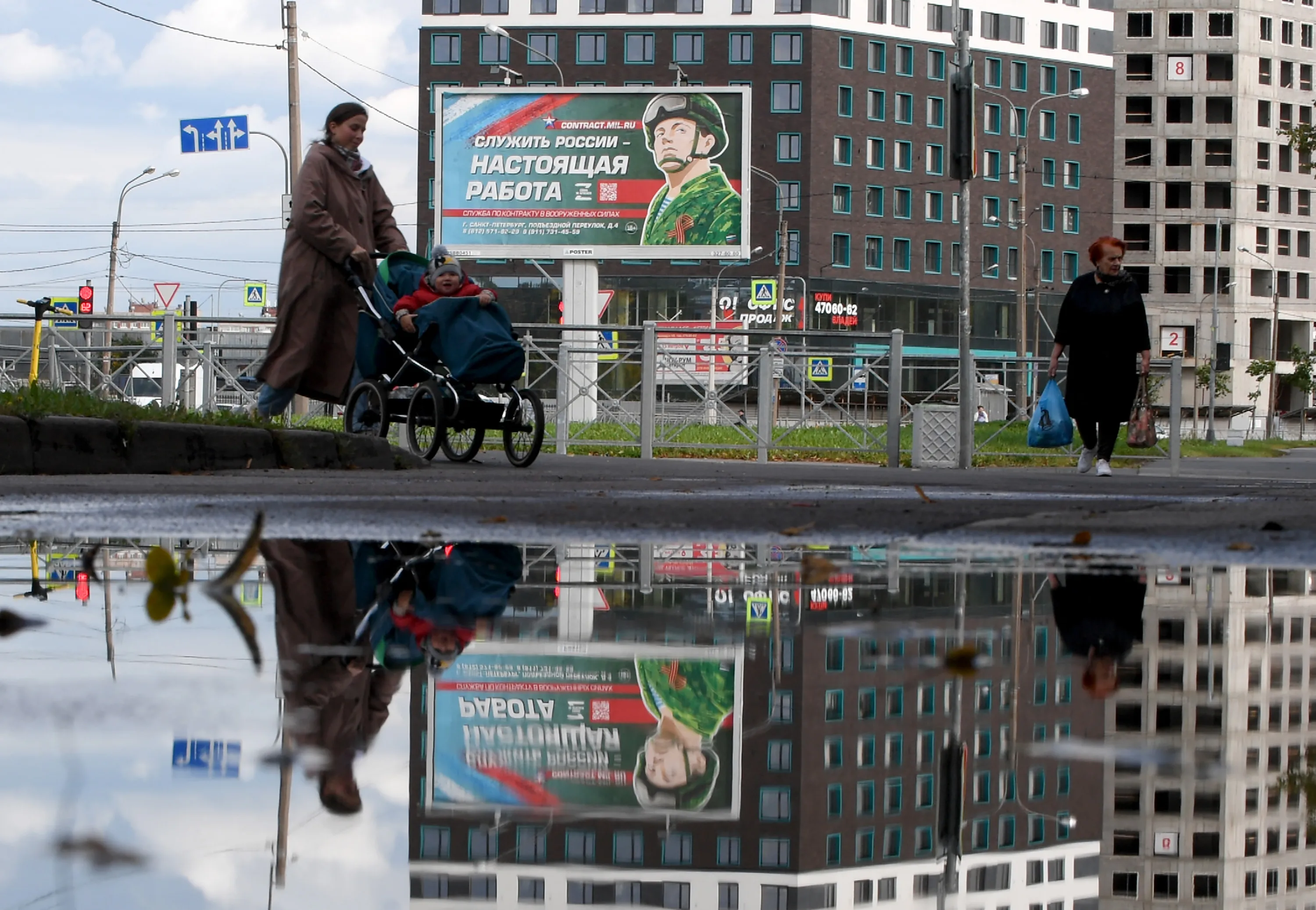 A billboard promoting contract army service with an image of a serviceman and the slogan reading "Serving Russia is a real job" in Saint Petersburg, Russia, on Sept. 20.