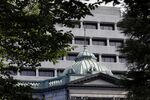 The Bank of Japan (BOJ) headquarters stands in Tokyo, Japan.d to the Topix equities index and flexibility in bond operations.
