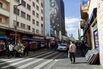 Shoppers pass retail stores on 25 de Marco Street in Sao Paulo, Brazil.