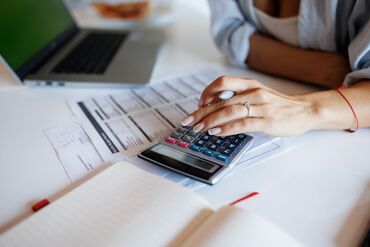 Woman calculating finances at home
