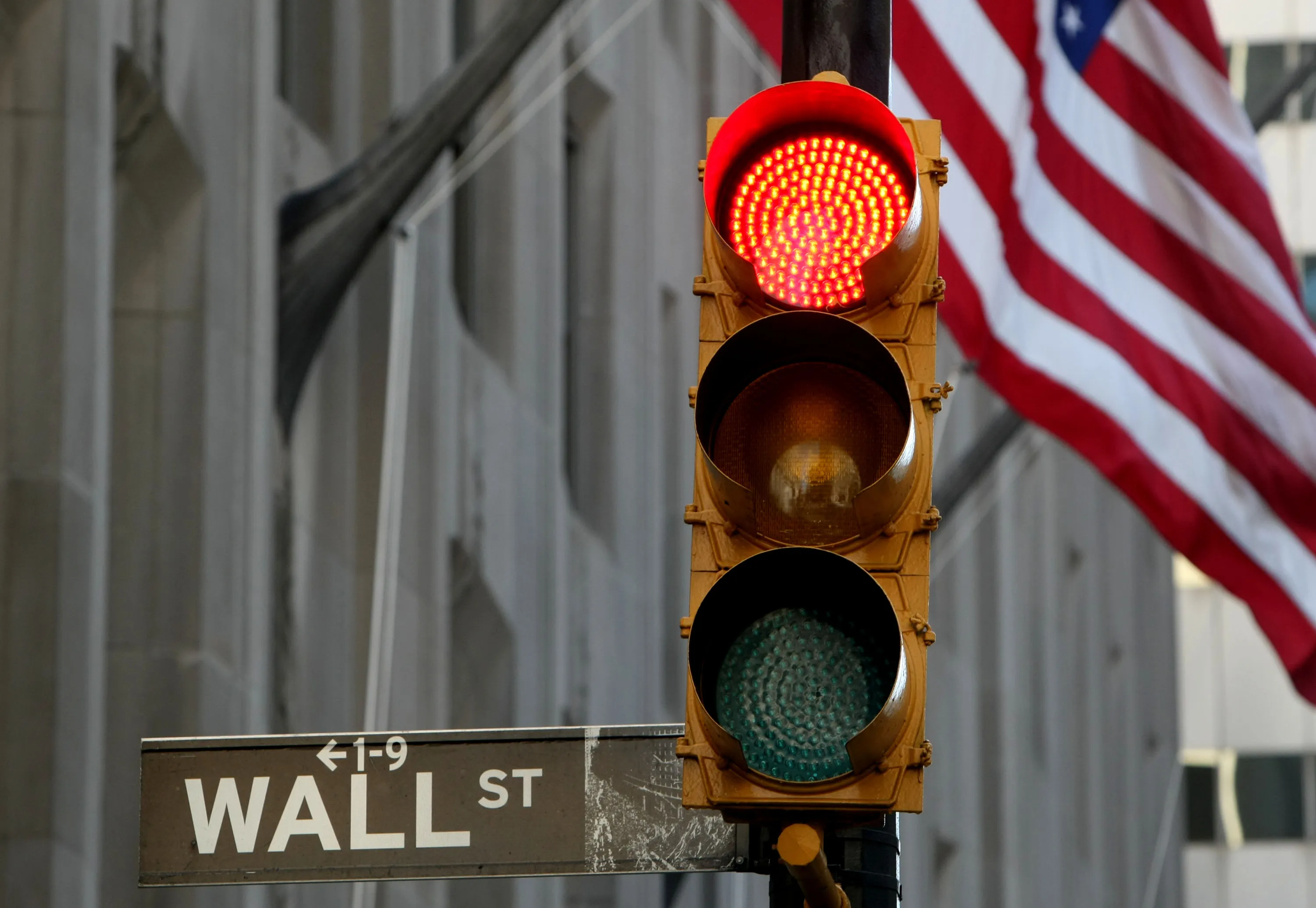 A Wall Street sign hangs from a lamp post in New York.