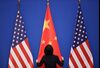 BEIJING, CHINA - JULY 09: A Chinese woman adjusts the Chinese flag before the opening ceremony of the 6th China-U.S. Security and Economic Dialogue and 5th round of China-U.S. High Level Consultation on People-to-People Exchange at Diaoyutai State Guest House on July 9, 2014 in Beijing, China. (Photo by Feng Li/Getty Images)