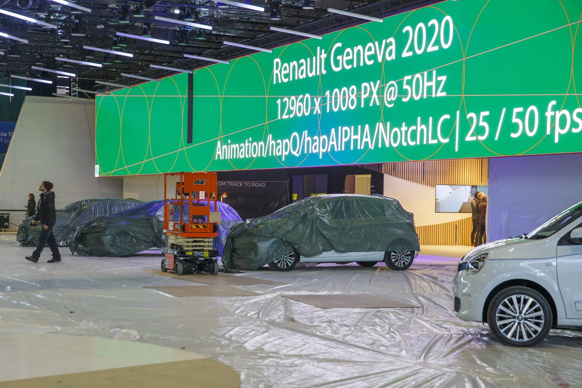 Workers stop preparations for the 90th Geneva International Motor Show on Feb. 28.
