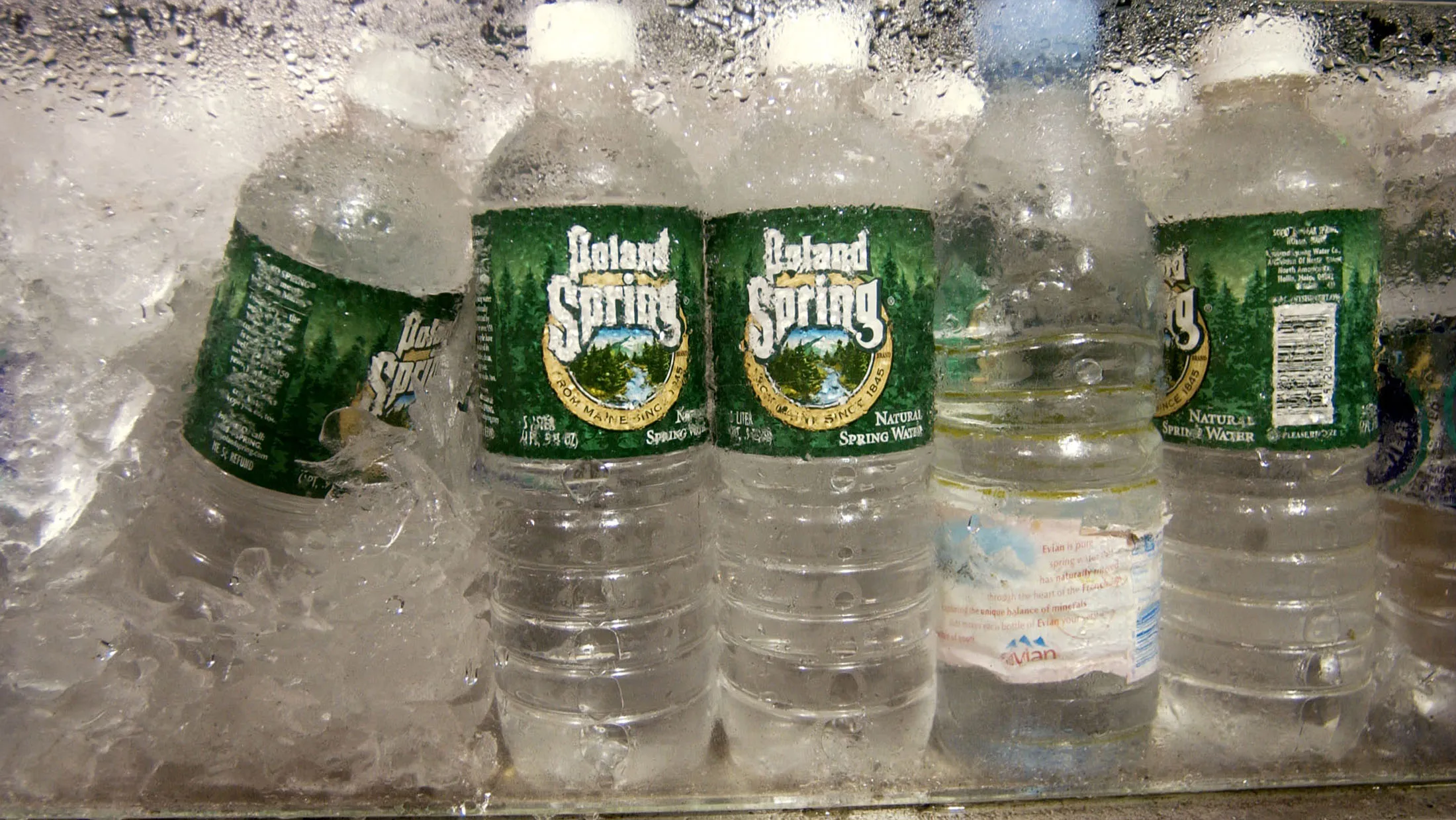 Bottles of Poland Spring water sit on display at a grocery store in New York on June 19, 2003. Poland Spring, first bottled by the Ricker family in Maine in 1845, is now taken from wells as far as 30 miles away from the original source, which hasn't flowed since 1967, the suit says. One source is a parking lot by the side of a road used by hundreds of trucks, and another is near a former dump and below a site that used to be fertilized with sewage, the suit says.
