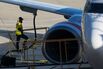 Ground crew refulling a jet.