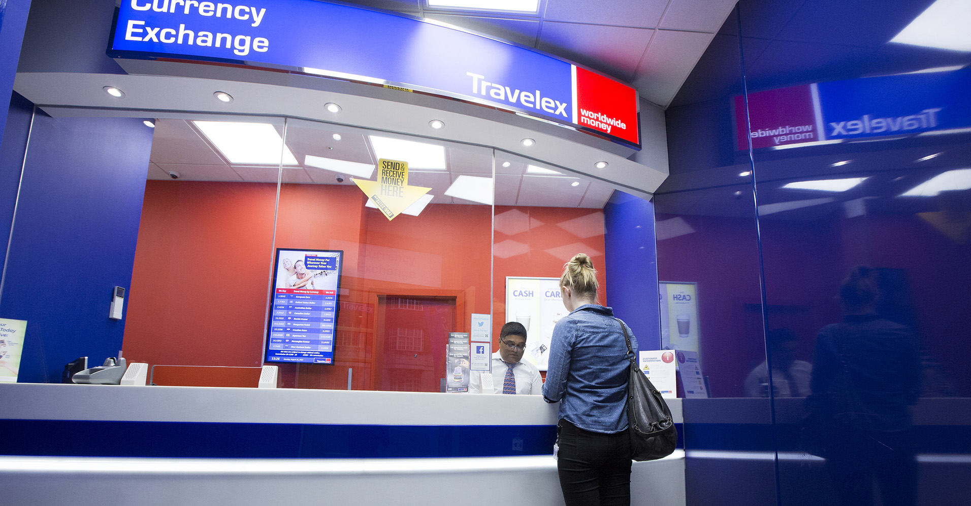 A customer changes currency at a Travelex currency exchange in London.