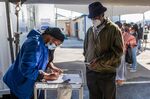 A worker registers a resident's details for the Covid-19 vaccine in the Khayelitsha township of Cape Town.&nbsp;