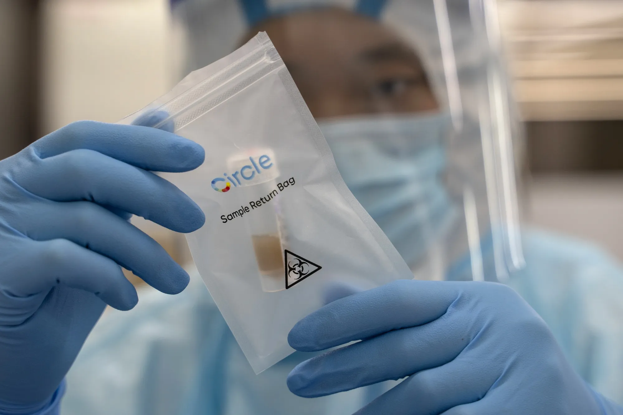 A lab technician&nbsp;holds up a saliva sample for Covid-19 testing&nbsp;in Hong Kong.