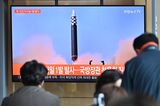 People watch a news broadcast showing footage of a North Korean missile test, in Seoul.