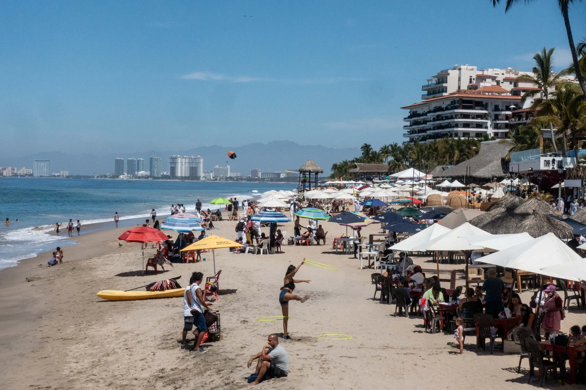 People sit at a beach in Puerto Vallarta, Jalisco state, Mexico.