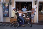 People order at the walkup window of a bar in Key West, Florida on March 25.